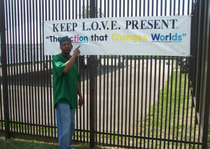 a picture of a keep love present banner hanging on a fence in camden, nj