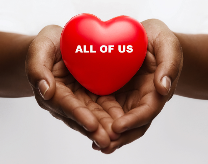 a heart sitting in the palm of two hands promoting the idea lets love together, all of us